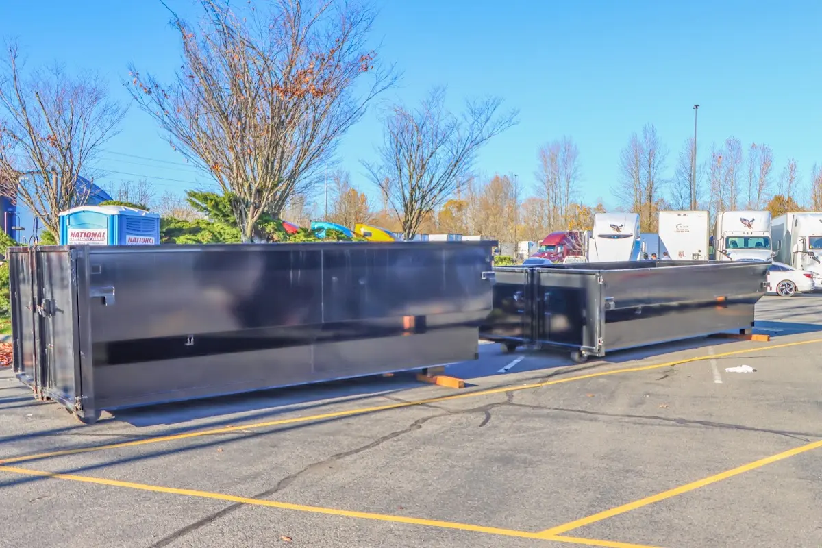 Professional dumpster rental service with roll-off container on residential driveway in Brownwood